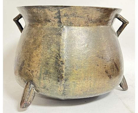A large seventeenth century bronze cauldron with tripod supports and angular side handles (h- 29cm, w- 43cm)