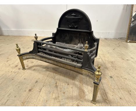 A reproduction cast iron brass mounted Regency style fire grate (h.55cm x l.74cm x w.41cm)