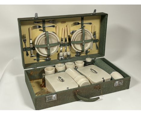 A Sirram 1960's picnic set in a fitted green case comprising, cutlery, plates, thermos, cups etc. (loss to handle and wear to