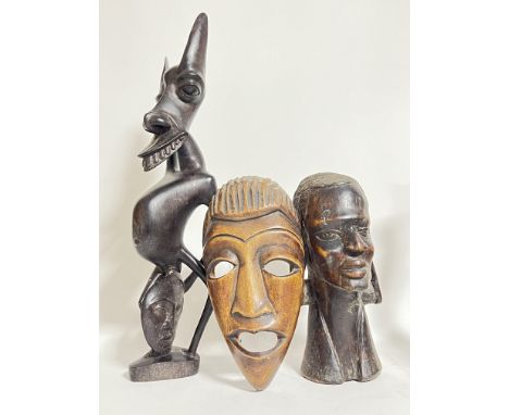 A group of African tribal art carved wooden sculptures comprising a large folkloric figure (h- 56cm), a mask, and a good bust