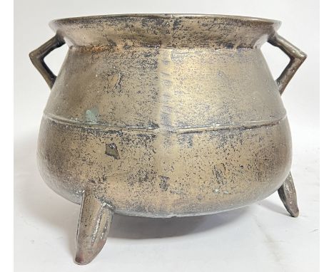 A seventeenth century bronze cauldron raised on tripod supports and with angular side handles on flared rim (h- 24cm, w- 35cm