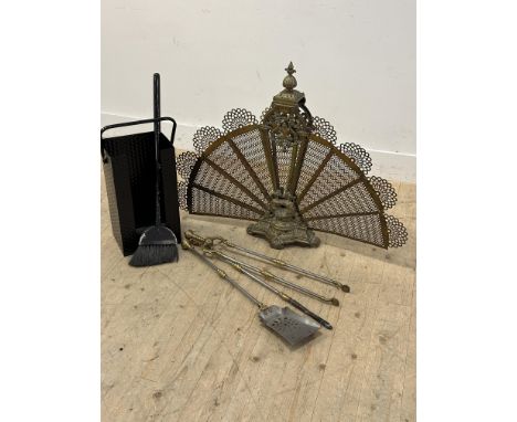 A black enamelled fire iron container with set of three steel brass mounted fire irons, brush and an expanding peacock firesc