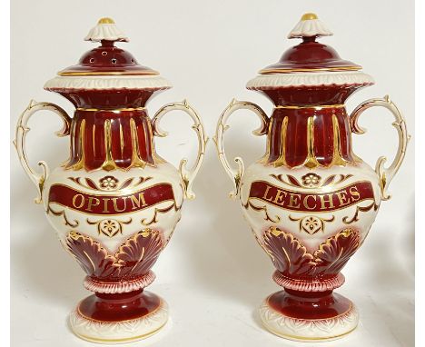 A pair of Blakeney reproduction gilt ceramic twin-handled apothecary/chemist's jars, one marked "Opium", the other "Leeches" 