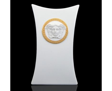Rosenthal Versace Gorgona vase, of concave form, decorated in relief with medusa masks and gilt greek key borders upon a whit