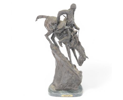 After Frederick Remington; The Mountain Man bronzed spelter figure of a native American trapper upon a marble base with plaqu