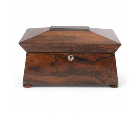 Victorian rosewood tea caddy, of sarcophagus form with mother of pearl escutcheon, upon four squat bun feet, H19cm