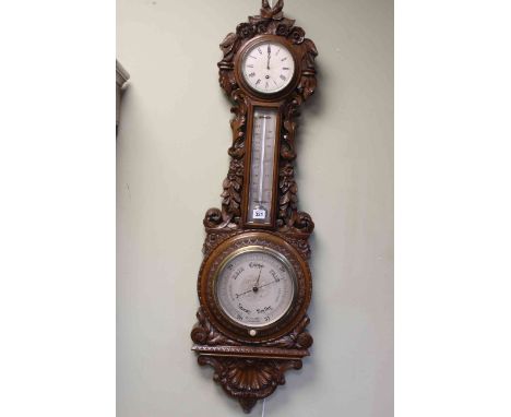 Impressive Victorian carved oak aneroid barometer, clock and thermometer, Dolland, London, having silvered dials set in folia