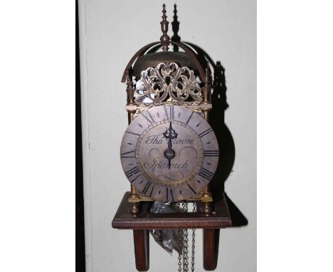 Reproduction brass lantern clock with wall bracket.