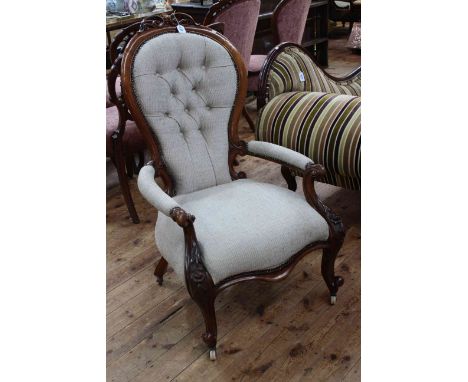 Victorian mahogany framed open armchair in light buttoned fabric.