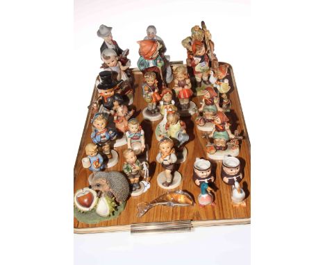 Collection of fourteen Hummel figures and other ornaments.