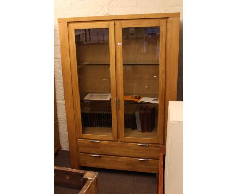 Contemporary light display cabinet having two glazed panel doors above two long drawers 129cm by 191cm, together with a Russe