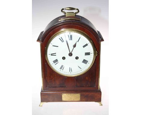 Mahogany mantel clock with French striking movement, having brass handle and splayed feet, 33cm.