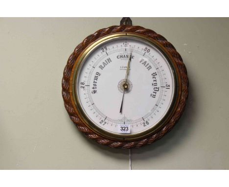 Oak cased aneroid barometer Lennie, Edinburgh, white dial with rope twist carved border 33cm diameter.