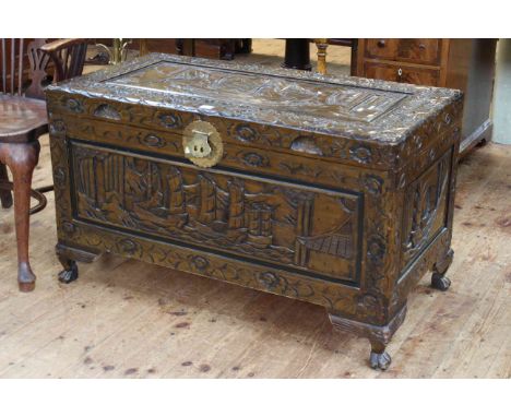 Oriental carved trunk on claw feet, 101cm by 59cm.
