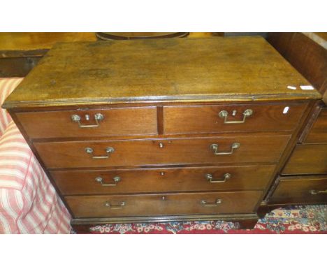 A Georgian mahogany square front chest of two short and three long drawers, raised on bracket feet