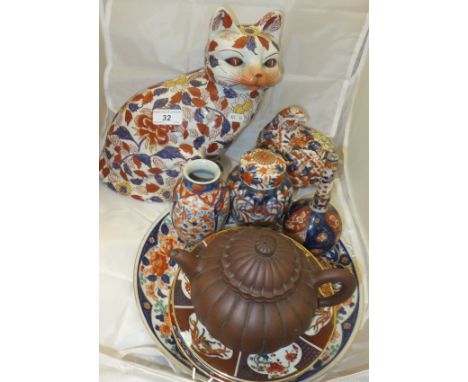 A collection of Chinese and Japanese ceramics to include a gourd-shaped teapot, a figure of a cat, two jars, bottle-shaped va