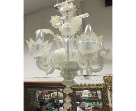 A five branch glass Venetian style ceiling light fitting decorated with flowers and leaves, the light shades formed as openin