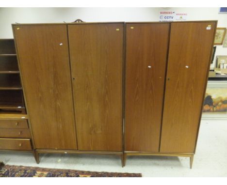 A McIntosh Furniture two door wardrobe together with a similar two door wardrobe and chest of three long and three short draw