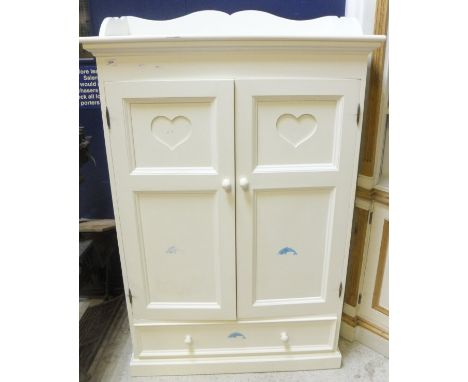 A white painted child's wardrobe, the two panelled doors with heart shaped decoration over a single drawer