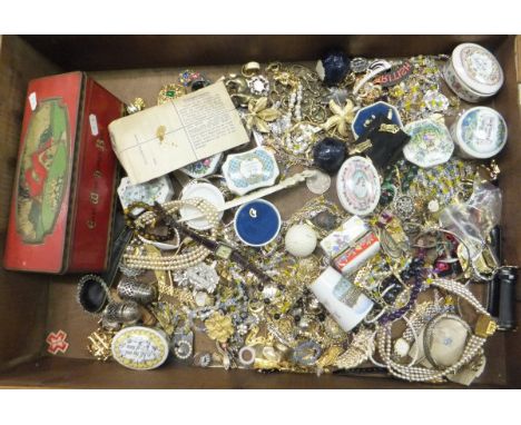 A display case containing various costume jewellery to include brooches, necklaces, etc, a tin containing assorted dominoes, 