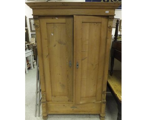A Continental pine two door wardrobe  CONDITION REPORTS Approx 112cm wide, 179cm high.  General wear, some splits and chips. 