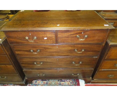 An early 19th Century mahogany chest of two short and three long graduated drawers on bracket feet