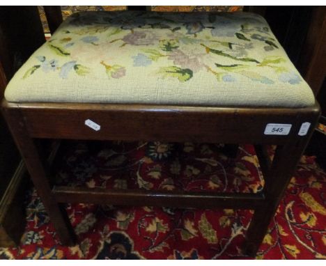 A George III mahogany dressing stool with tapestry drop-in seat on square chamfered supports united by a stretcher