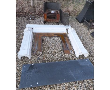 A white composite stone fire surround, together with cast iron fire and fire guard and a black slate effect fire kerb