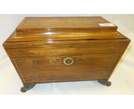 A rosewood and brass inlaid sarcophagus tea caddy on lion's paw feet in the Regency taste
