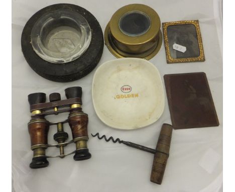 A box containing a print plate depicting a nude, two pairs of opera glasses, corkscrew, ashtray, etc