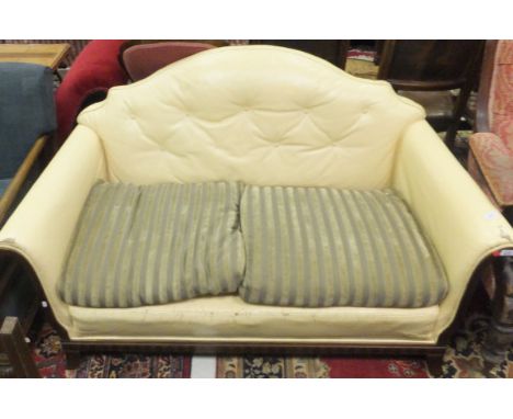 An early 20th Century Continental leather upholstered sofa with a mahogany frame, the leather painted cream