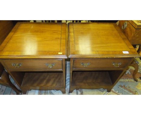 A pair of modern cherrywood bedside tables with single drawers above recesses on bracket feet