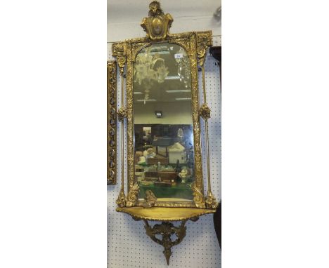 A 19th Century Continental giltwood and gesso framed pier glass with medallion decorated finial over a domed plate flanked by