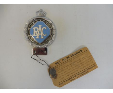 An RAC 1953 prototype car badge, with large lozenge enamel centre, still retaining a cardboard tag detailing the changes requ