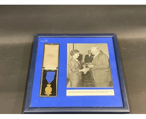 A framed and glazed RAC medal for 35 years service presented to Miss Winifred Cross, who looked after the Associated Clubs fo