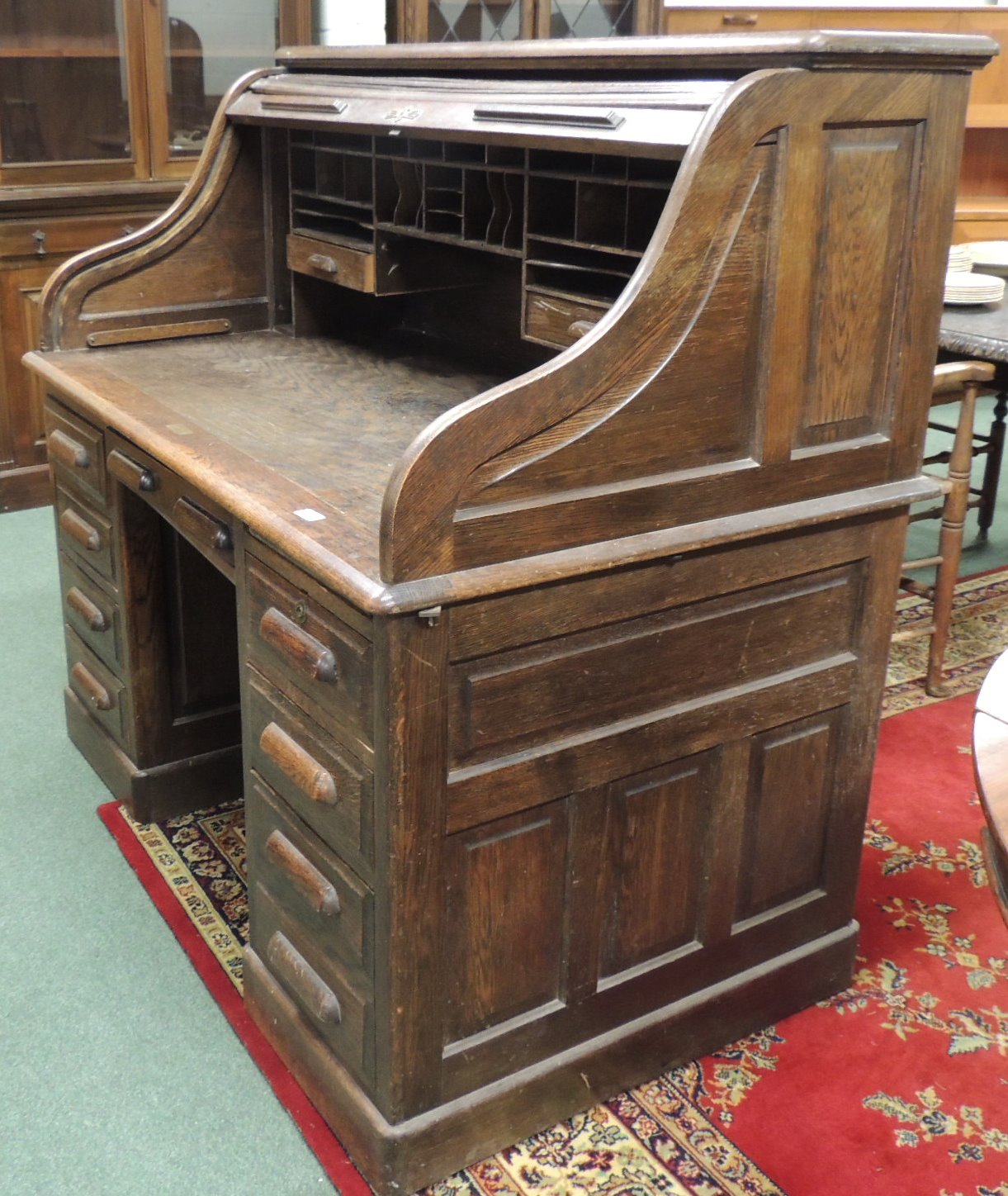 A Globe Wernicke oak roll top desk, 129cm high, 136cm wide.