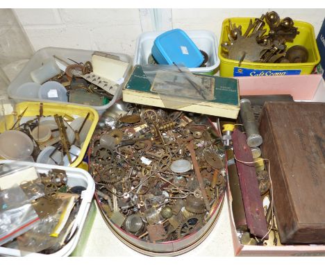 A selection of clock parts; cogs; pendulums; keys; etc.
