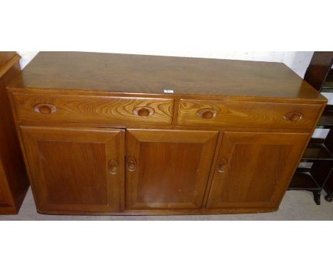 An Ercol light elm sideboard of 3 cupboards and 3 drawers