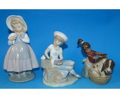 A Lladro group:  "Sunday's Child"; another Lladro group; a Nao figure