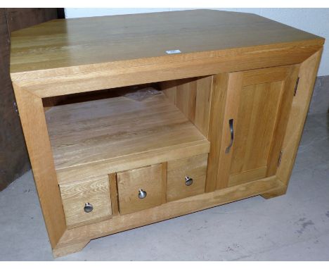 A modern light oak TV stand with shelf and drawers under