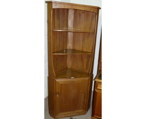 An Ercol light elm full height corner cupboard with open shelves and cupboard under