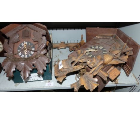 A large cuckoo clock in need of restoration; 2 similar smaller