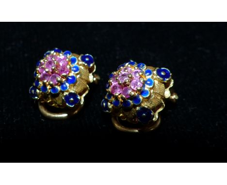 A pair of highly decorative yellow metal clip earrings inset with red stones and enamel, tests as 18 carat, 7 gms