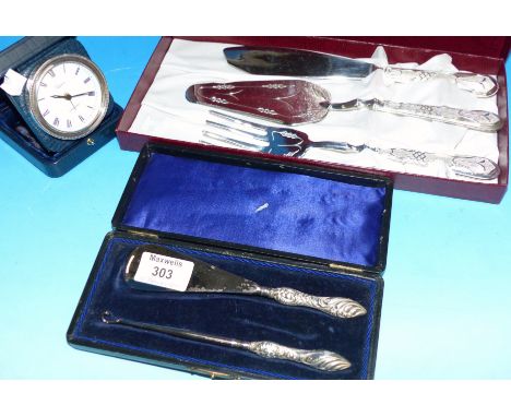 A travelling clock with silver rim; a silver handled button hook and shoe horn set; etc.