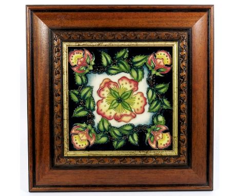 A Moorcroft tile, Rose and Wreath design, circa 2000, impressed marks, 15cm square, framed