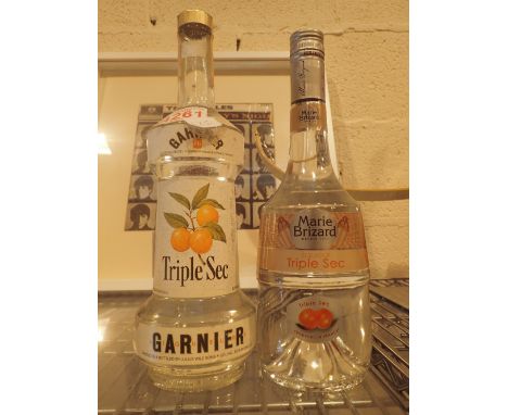 Mixed alcohol including 4/5 quart bottle Garnier Triple Sec liqueur and a Marie Brizzard 70cl triple sec   CONDITION REPORT: 