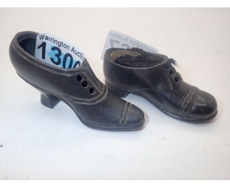Two late Victorian pewter shoe pin cushions, one ladies, one gents, one lacking cushion 