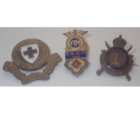 Three antique brass and enamel badges