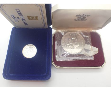 Silver Isle of Man £1 coin and a silver Isle of Man crown, both in cases