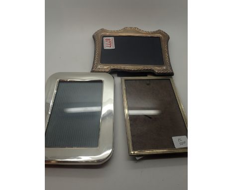 Three silver photograph frames, various sizes